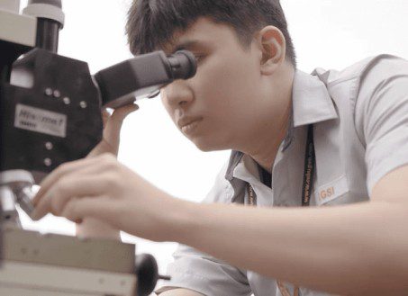 Skilled worker using microscope at Cebu manpower agency for technical and professional services